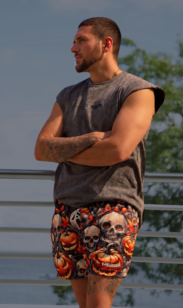 Man wearing MEROX Skull & Jack-o'-Lantern shorts