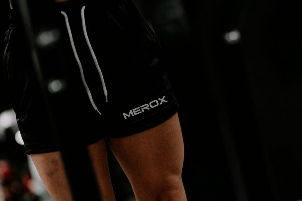 Woman wearing MEROX Solid Black 5-inch mesh shorts