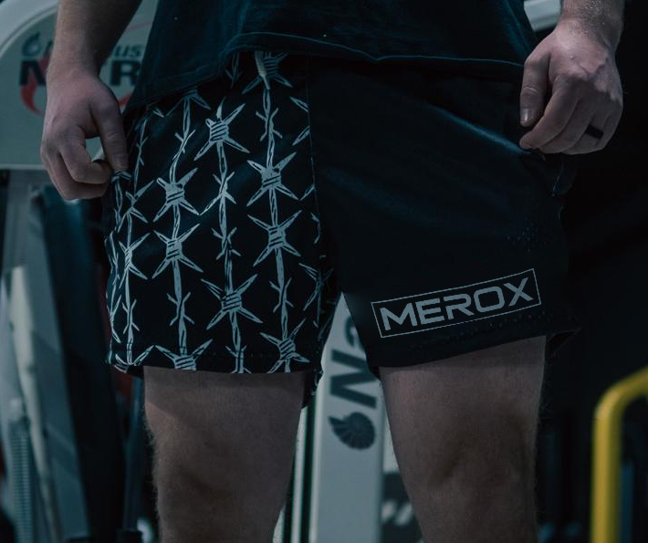 Man wearing MEROX Half Black Barbed Wire mesh shorts; approved existing-photo logo correction