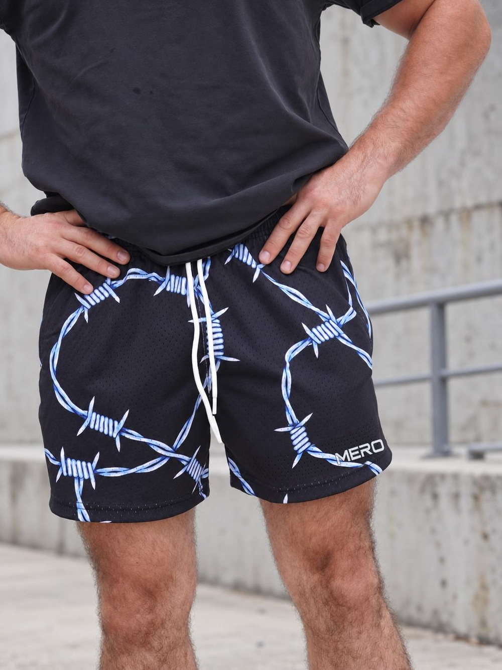 Approved matching male photo wearing MEROX Barbed Wire mesh shorts with outward MERO logo