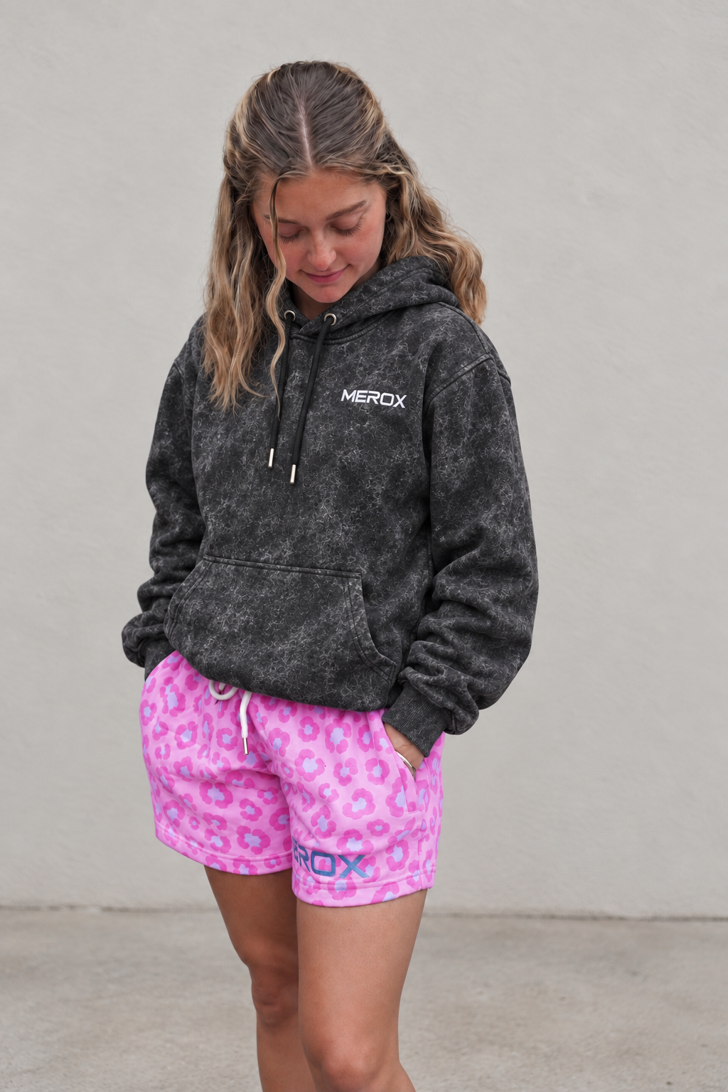 Female model wearing the MEROX Black Acid Wash embroidered hoodie