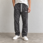 Male model wearing MEROX black acid wash straight-leg joggers