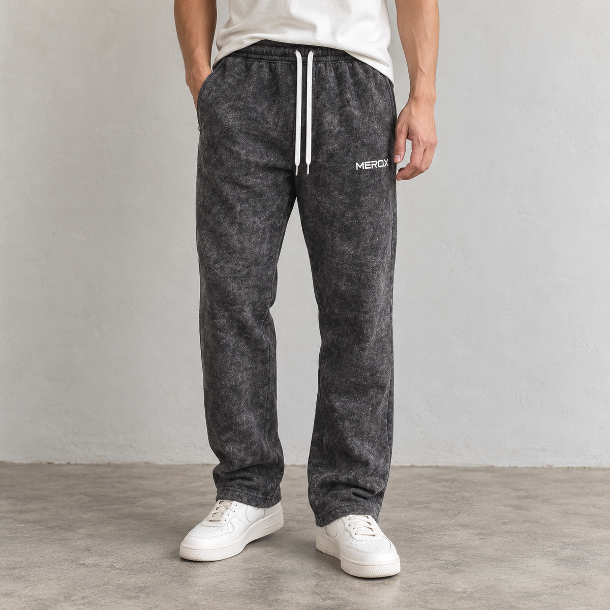 Male model wearing MEROX black acid wash straight-leg joggers