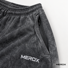 Concealed zipper pocket detail on MEROX black acid wash joggers