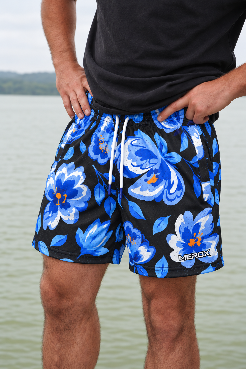 Real adult male model photo digitally adapted to MEROX Blue Floral shorts with small logo; AI-assisted garment visualization