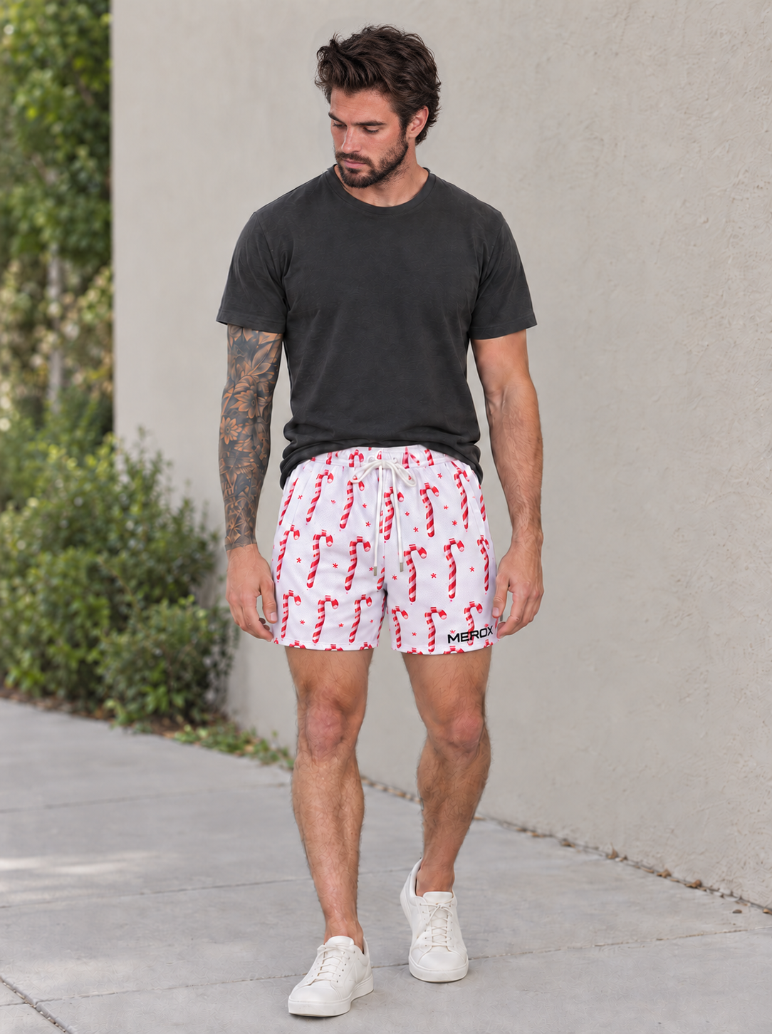 Male model wearing MEROX Candy Cane red and white mesh shorts