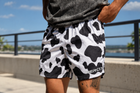Man wearing MEROX Cow Print shorts