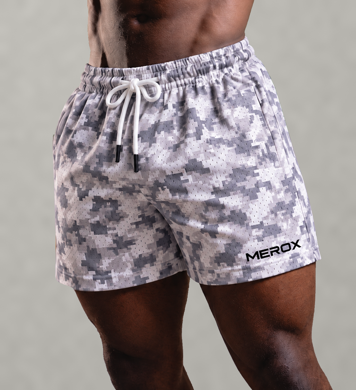Man wearing MEROX Digital Snow Camo 5-inch mesh shorts