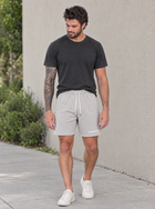 Male model wearing MEROX gray cotton shorts outdoors
