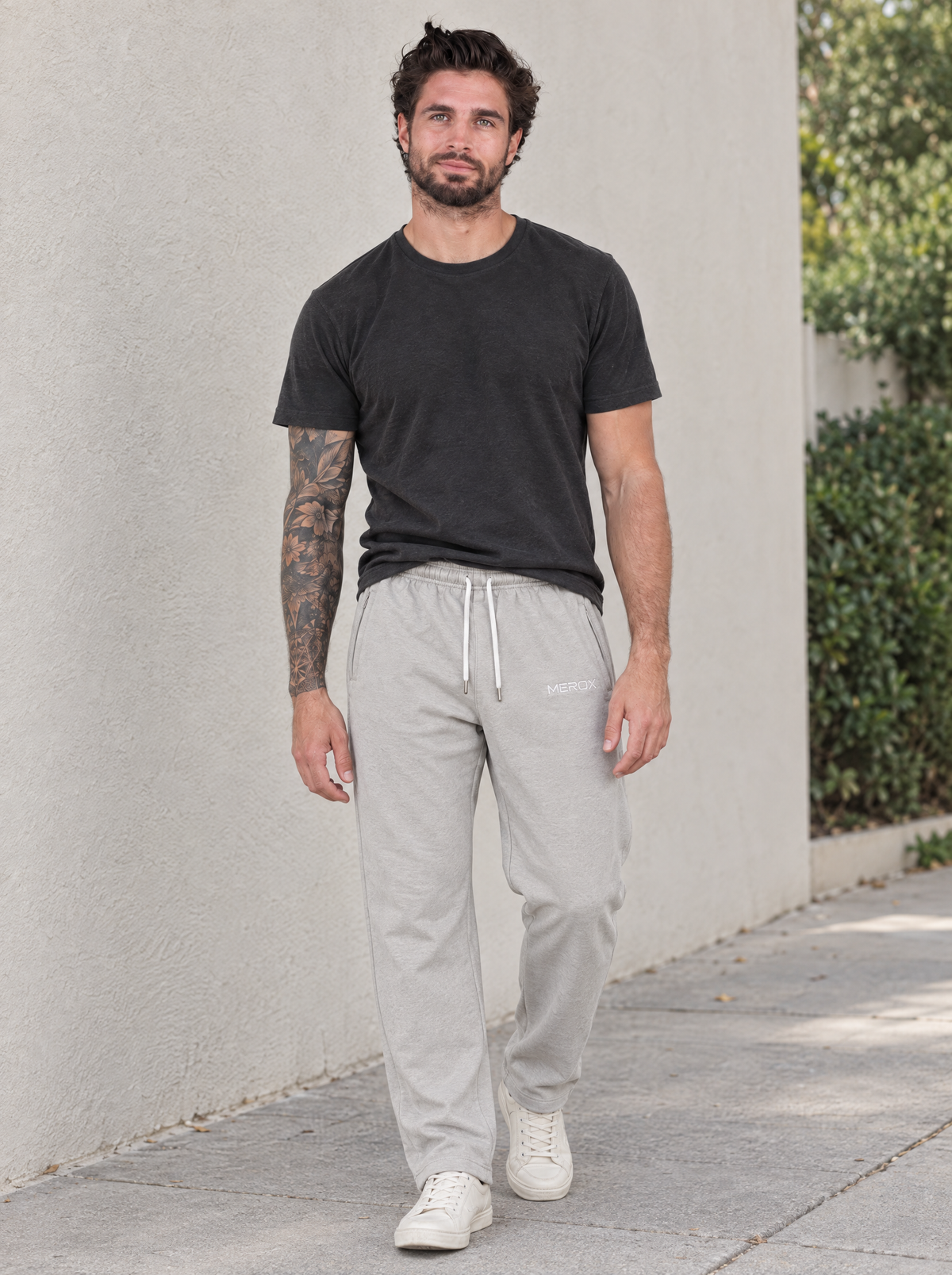 Male model wearing MEROX gray joggers outdoors