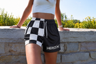 Approved female model wearing MEROX Black and White Checkered mesh shorts