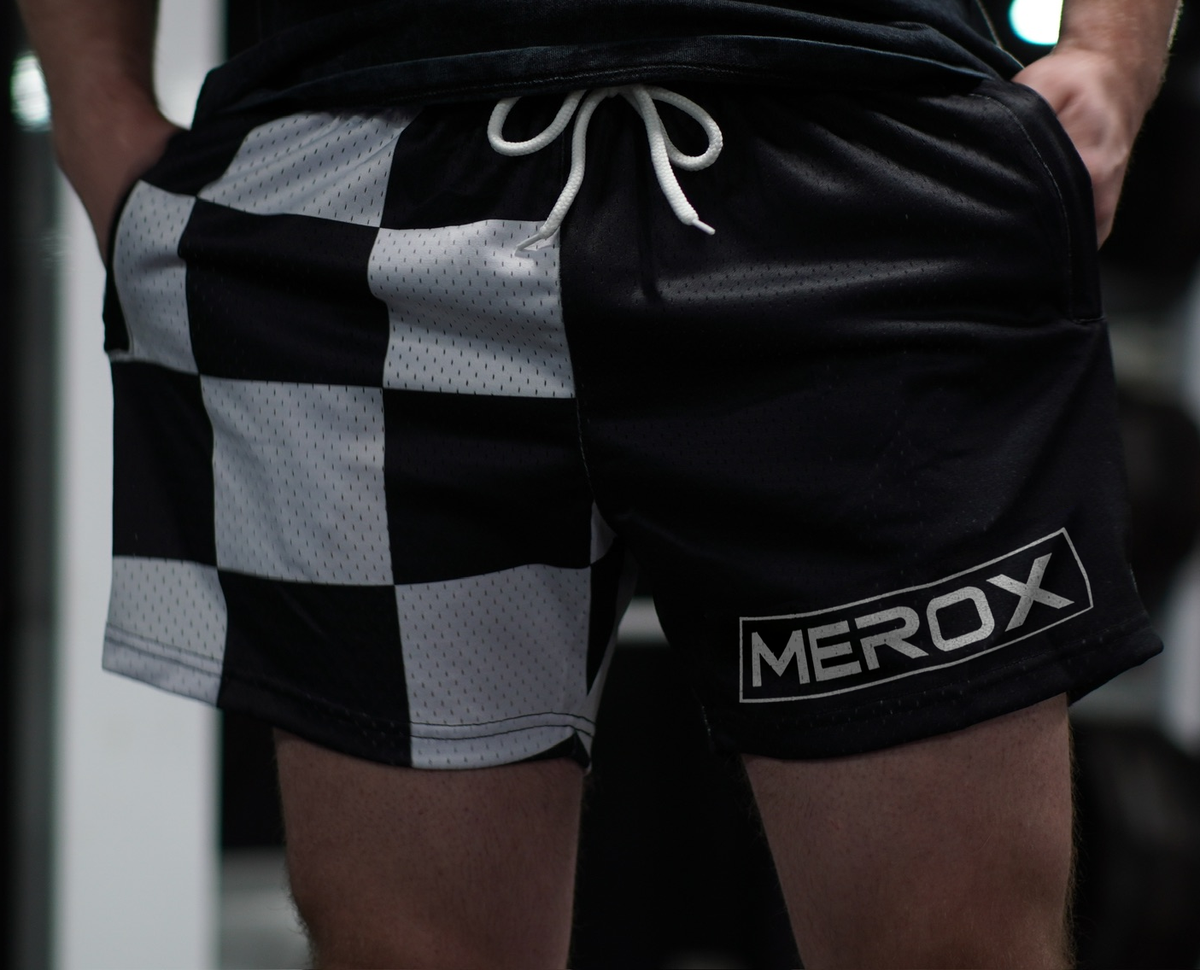 Approved male model wearing MEROX Black and White Checkered mesh shorts