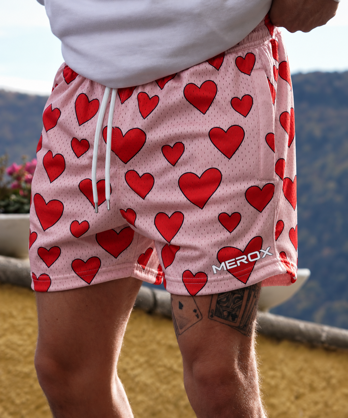 Man wearing MEROX Valentine Hearts mesh shorts