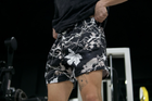 Model wearing MEROX Black and White Maple Camo 5-inch mesh shorts