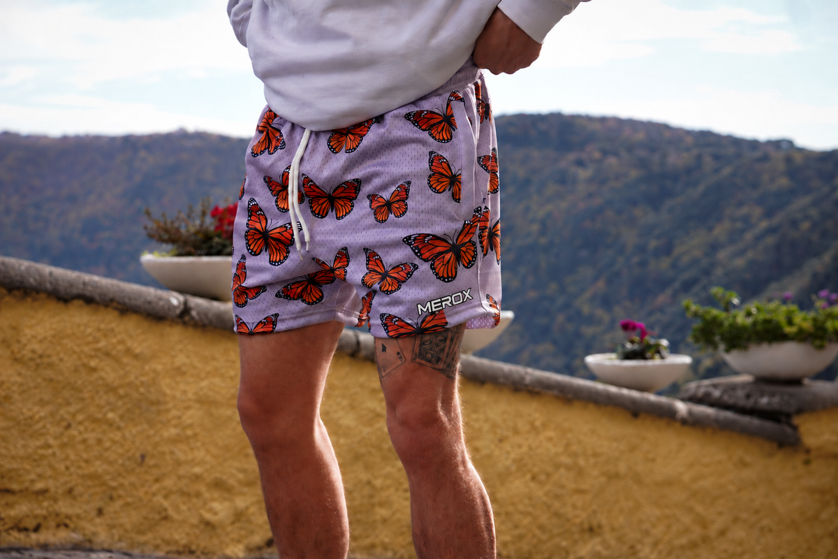 Approved male model wearing MEROX Monarch Butterfly mesh shorts