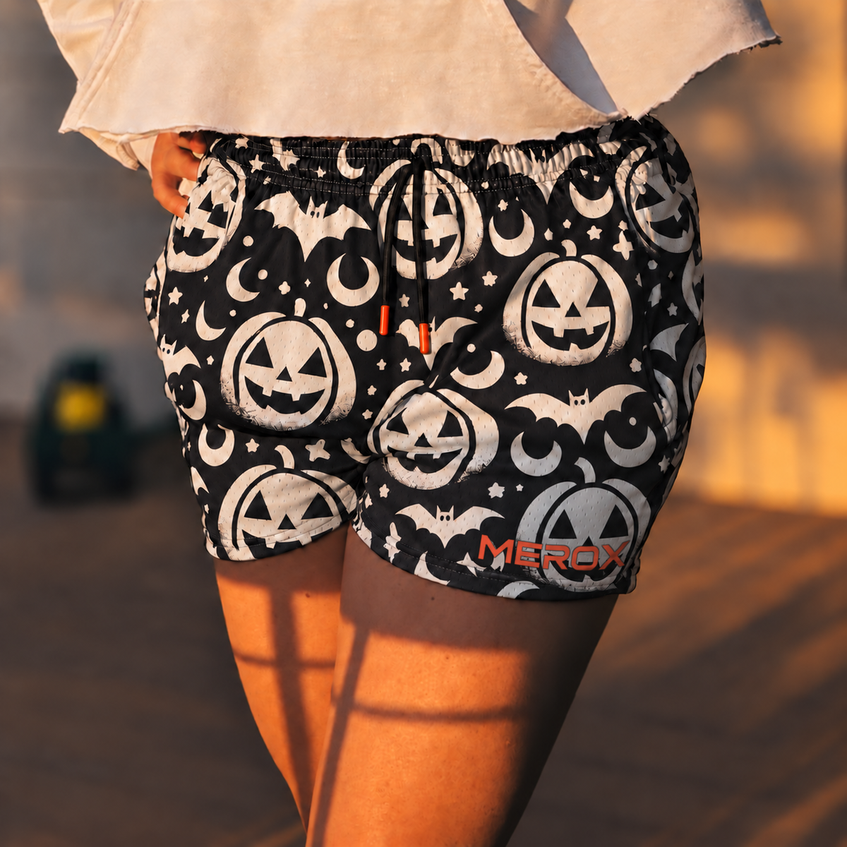 Approved female model wearing MEROX Black and White Jack-o-Lantern mesh shorts