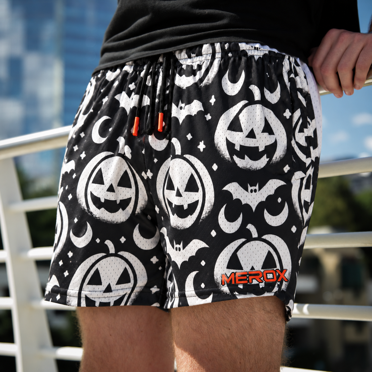 Approved male model wearing MEROX Black and White Jack-o-Lantern mesh shorts