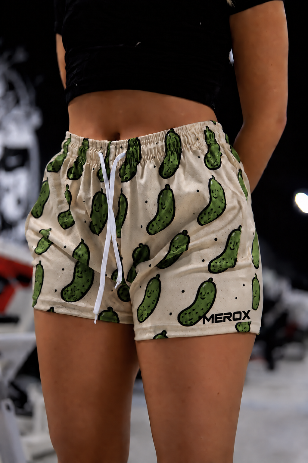 Woman wearing MEROX Pickle mesh shorts, approved logo-left photograph