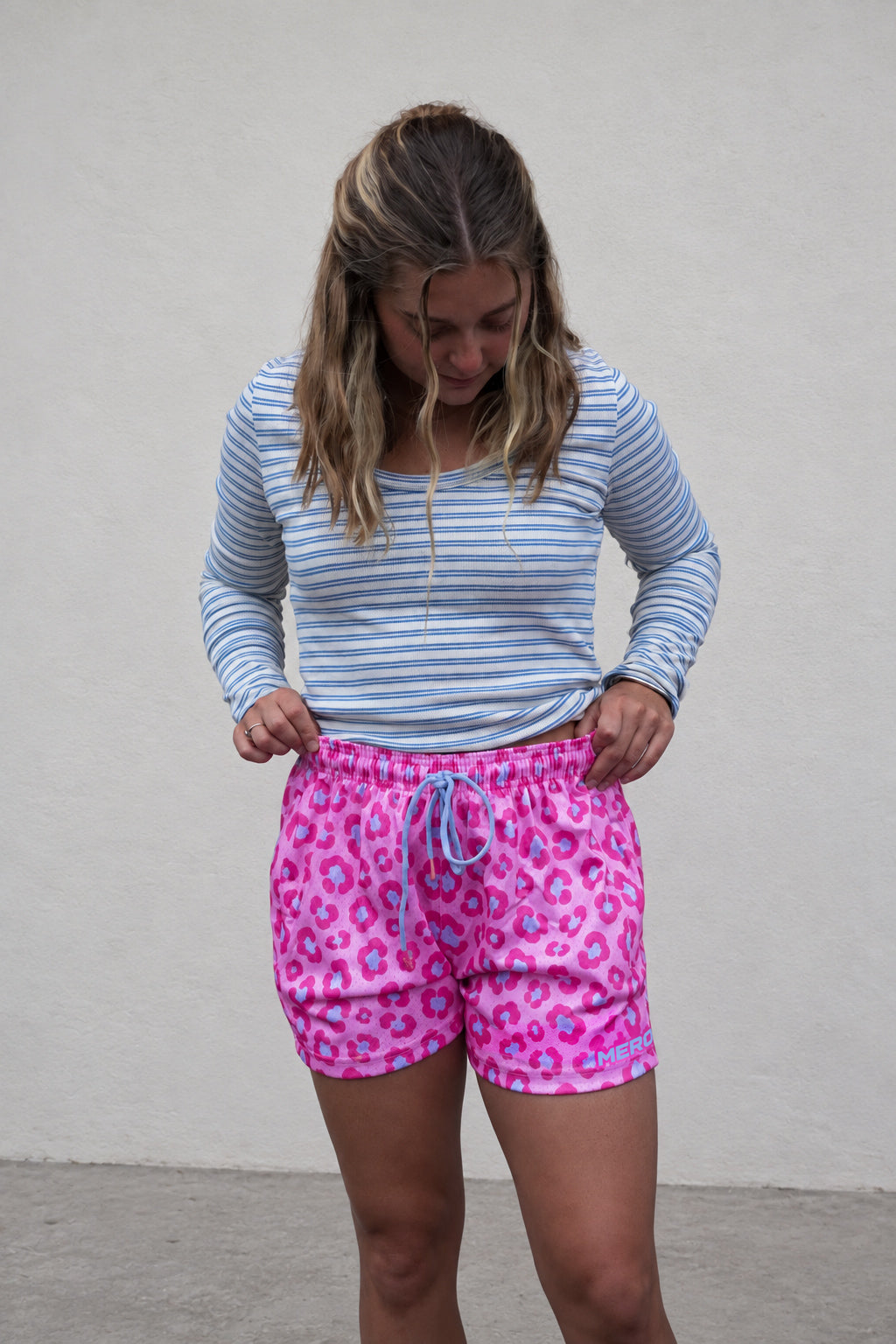Woman wearing MEROX Pink and Blue Leopard mesh shorts, approved female B logo revision