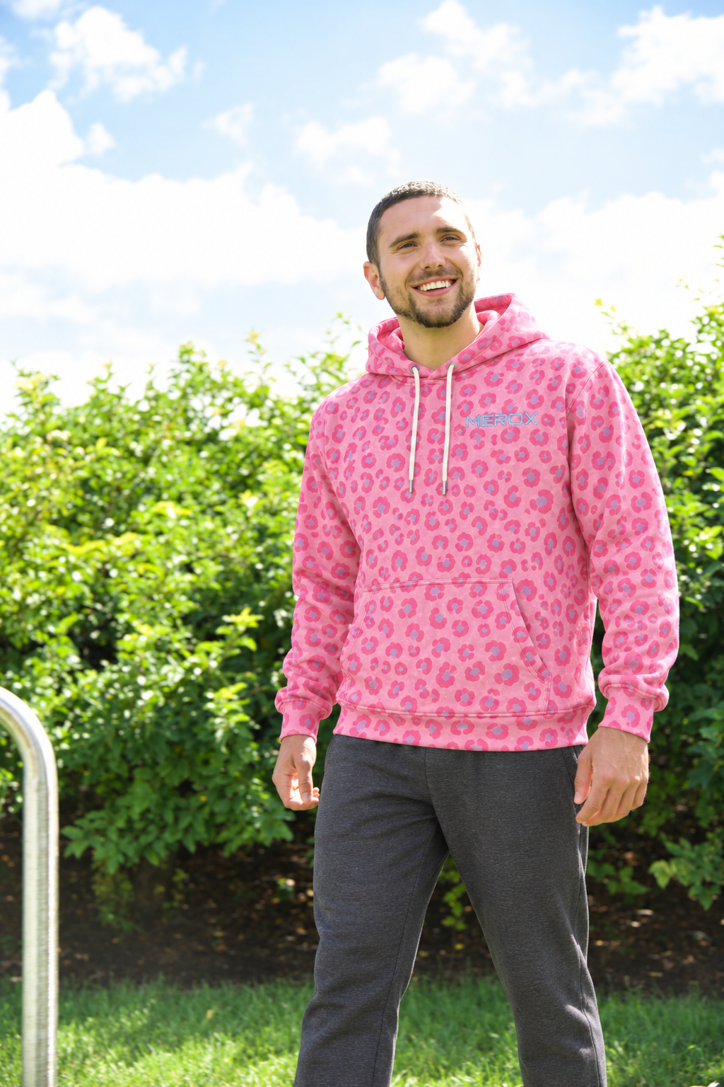 Man wearing MEROX Pink Leopard Cheetah embroidered hoodie outdoors