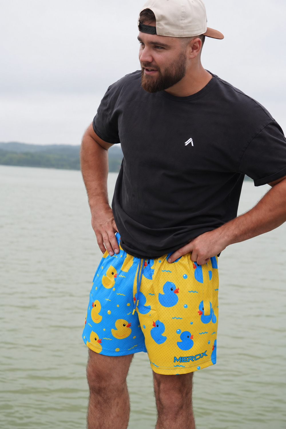 Approved male B wearing MEROX Rubber Duck mesh shorts with corrected small lower-right logo