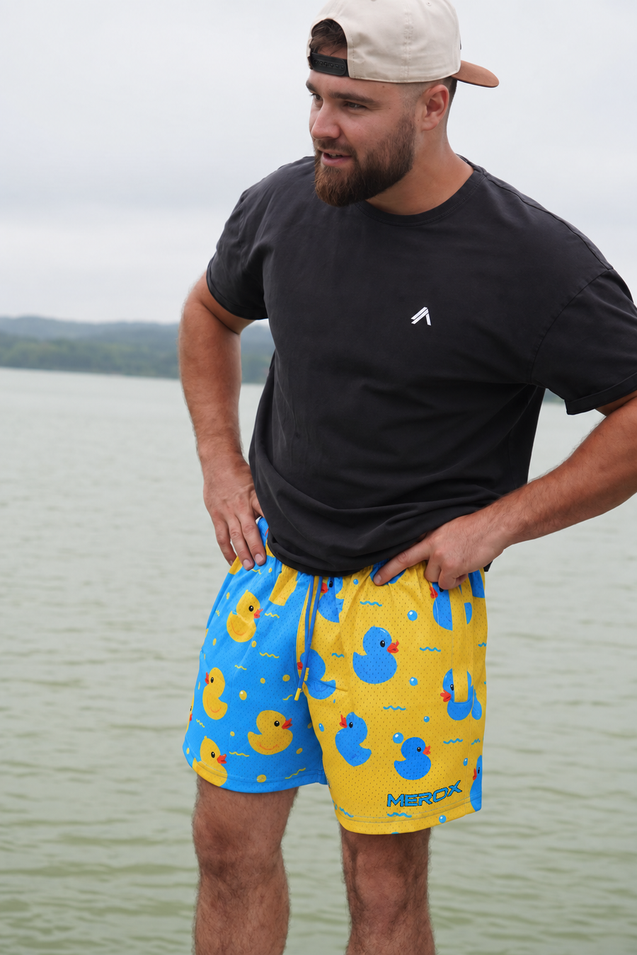Approved male B wearing MEROX Rubber Duck mesh shorts with corrected small lower-right logo