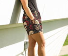MEROX Skull and Roses mesh shorts on a female model, side view