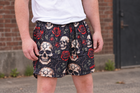 Man wearing MEROX Skull and Roses 5-inch mesh shorts, approved frontal view with smaller partial logo