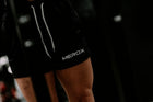 Woman wearing MEROX Solid Black 5-inch mesh shorts