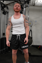 Man wearing MEROX Solid Black mesh shorts, approved large centered logo