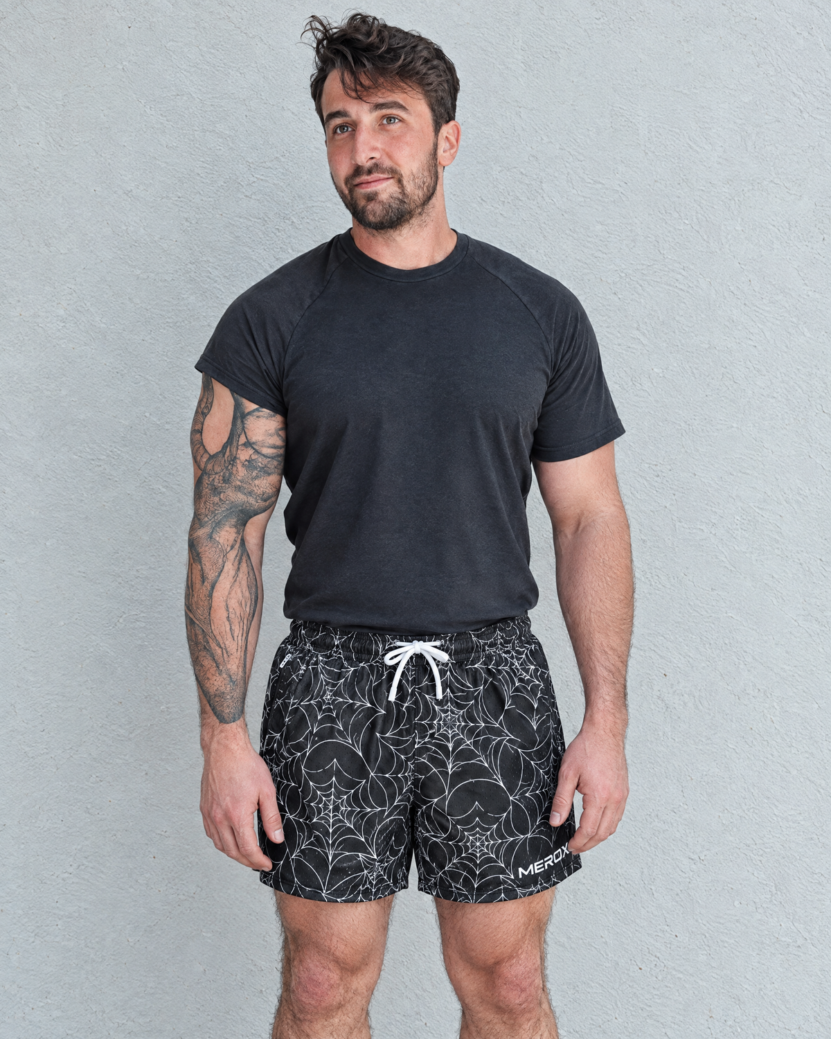 Male model wearing MEROX black-and-white Spider Web 5-inch mesh shorts