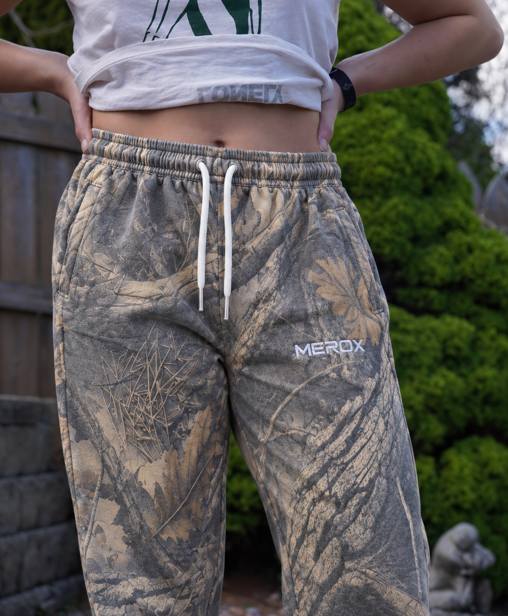 Approved female model wearing MEROX Vintage Woodland Camo joggers