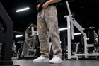 Approved male model wearing MEROX Vintage Woodland Camo joggers